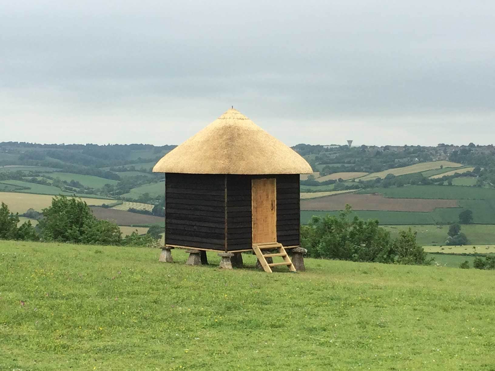 A unique thatched finial, adding a personal touch to the roof's peak.
