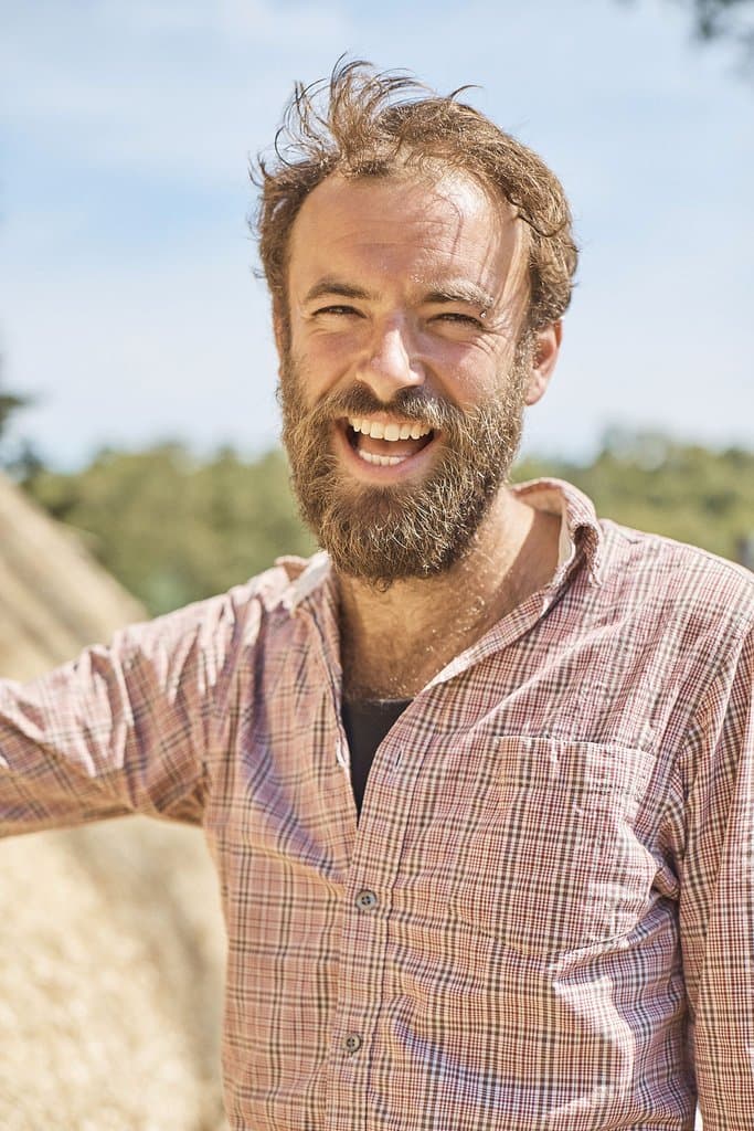 Christopher Keelty, master thatcher based in Frome, Somerset, working on a thatched roof
